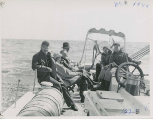 Image: Group on quarter deck- Webster, Stan, Barney, Happy, Miriam, Al at Wheel